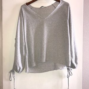 Gray sweater with ties on sleeves